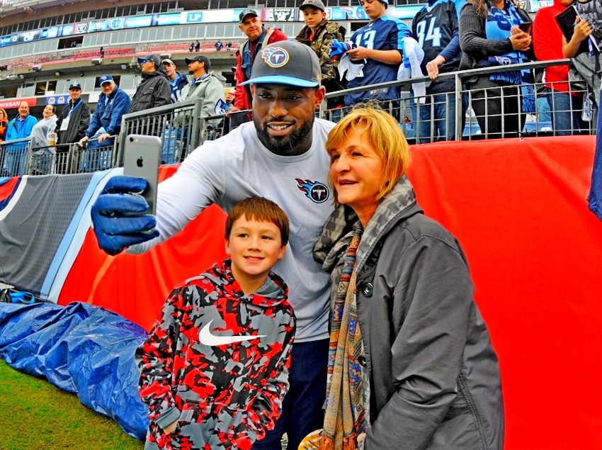 Nov 29, 2015; Nashville, TN, USA; Tennessee Titans tight end Delanie Walker (C) poses for a photo with fans prior to the game against the Oakland Raiders at Nissan Stadium. Mandatory Credit: Christopher Hanewinckel-USA TODAY Sports